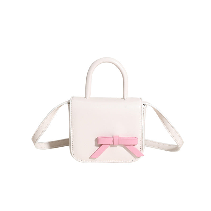 Stylish Creative Carry-On Girls’ Portable Mini Bow Princess Crossbody bag in white, black, pink, and silver colors with a cute bow design.