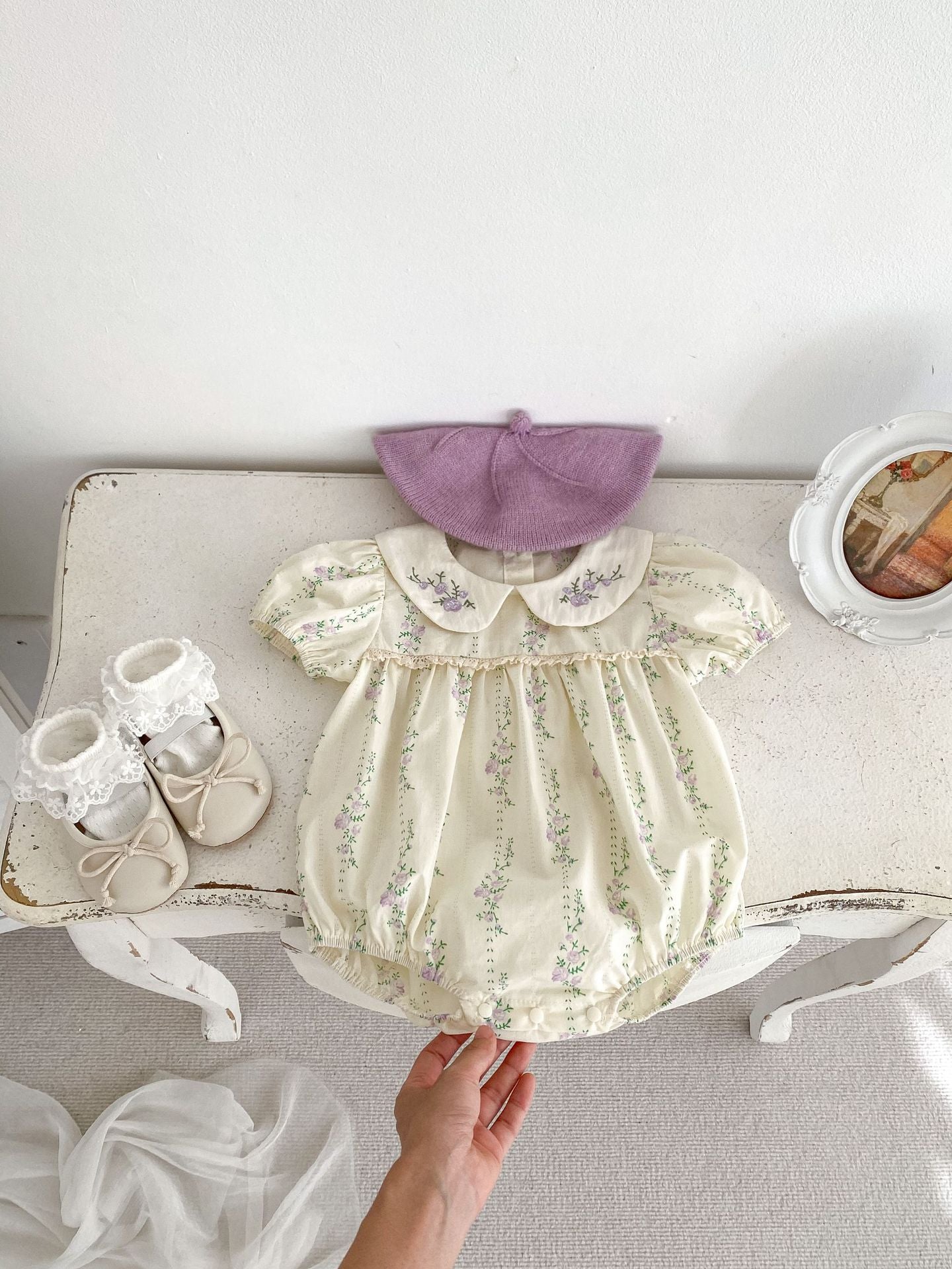 Summer baby girls onesie featuring a floral and vine pattern in beige cotton, perfect for warm weather.