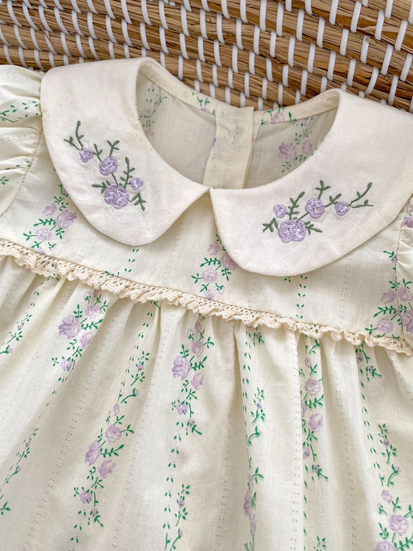 Summer baby girls onesie featuring a floral and vine pattern in beige cotton, perfect for warm weather.
