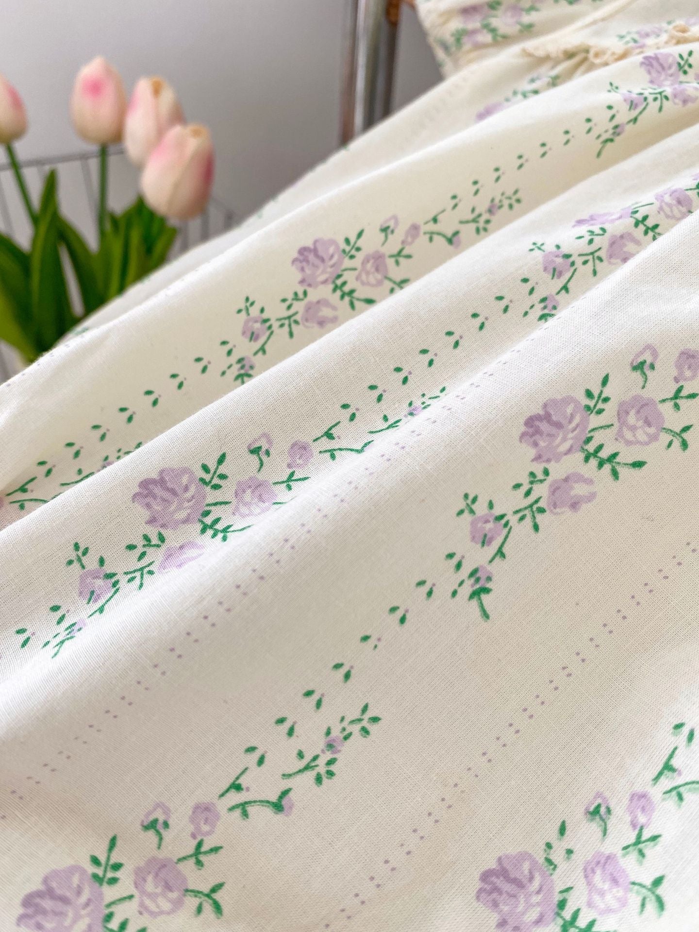 Summer baby girls onesie featuring a floral and vine pattern in beige cotton, perfect for warm weather.