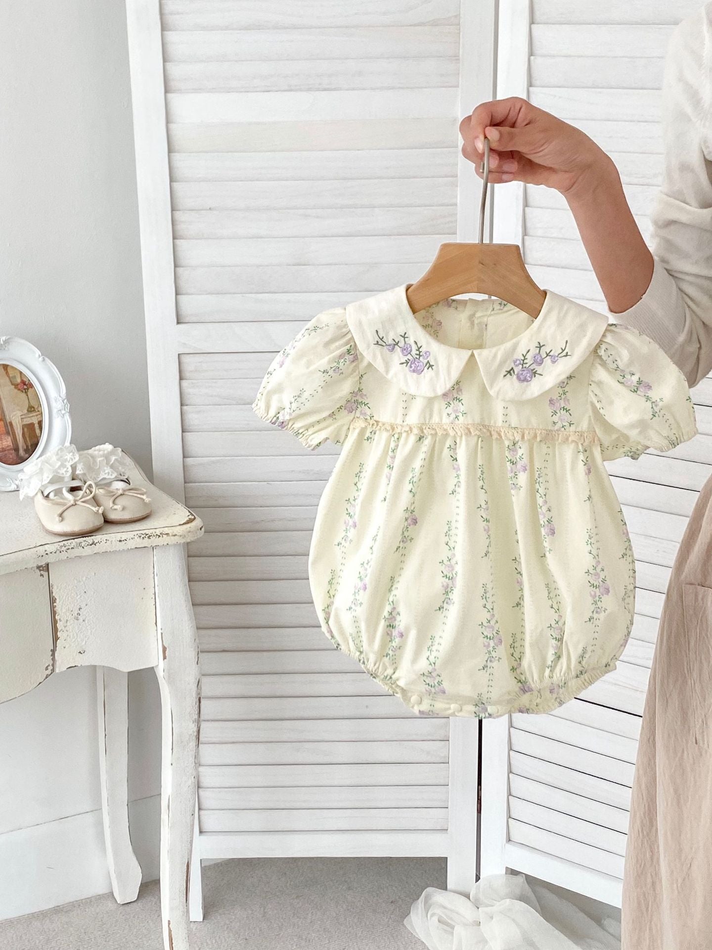 Summer baby girls onesie featuring a floral and vine pattern in beige cotton, perfect for warm weather.