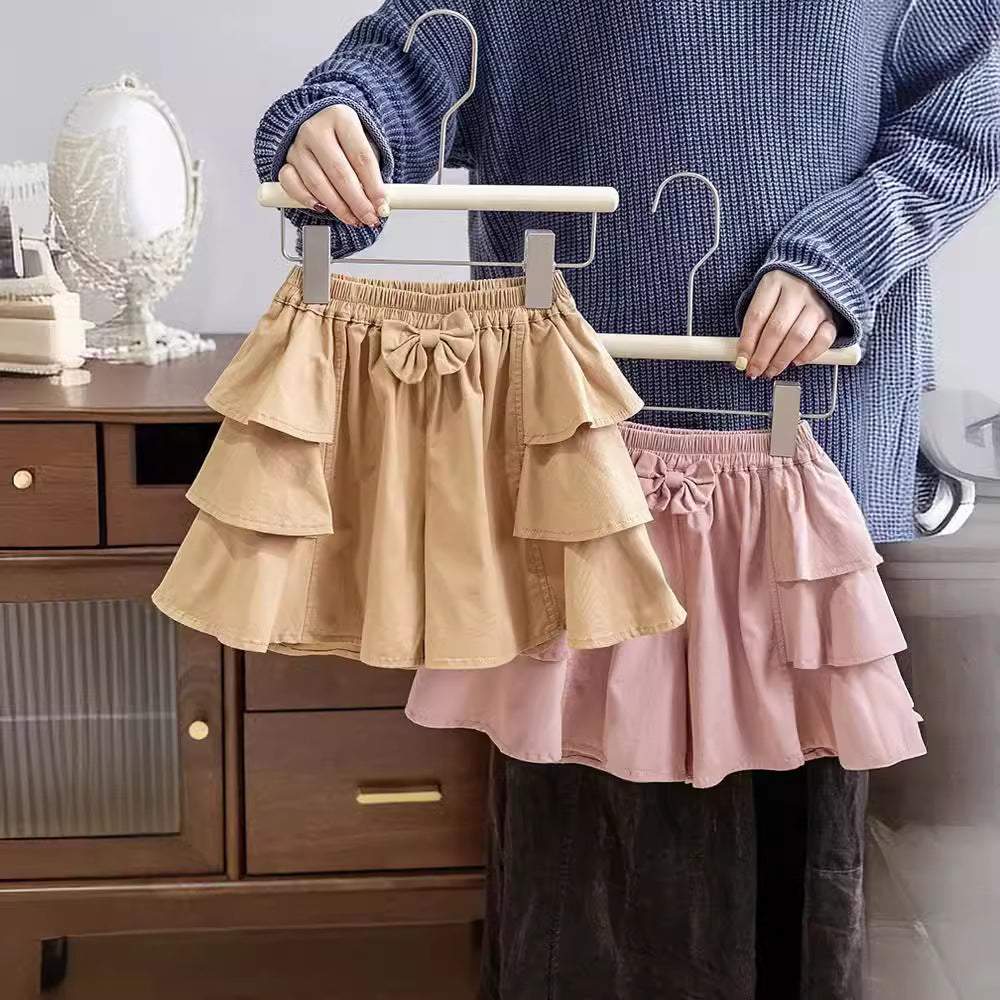 Summer Baby Kids Girls Bows Tied Sweet Casual Pleated Skirt in pink and coffee colors, showcasing a cute bow tie design.