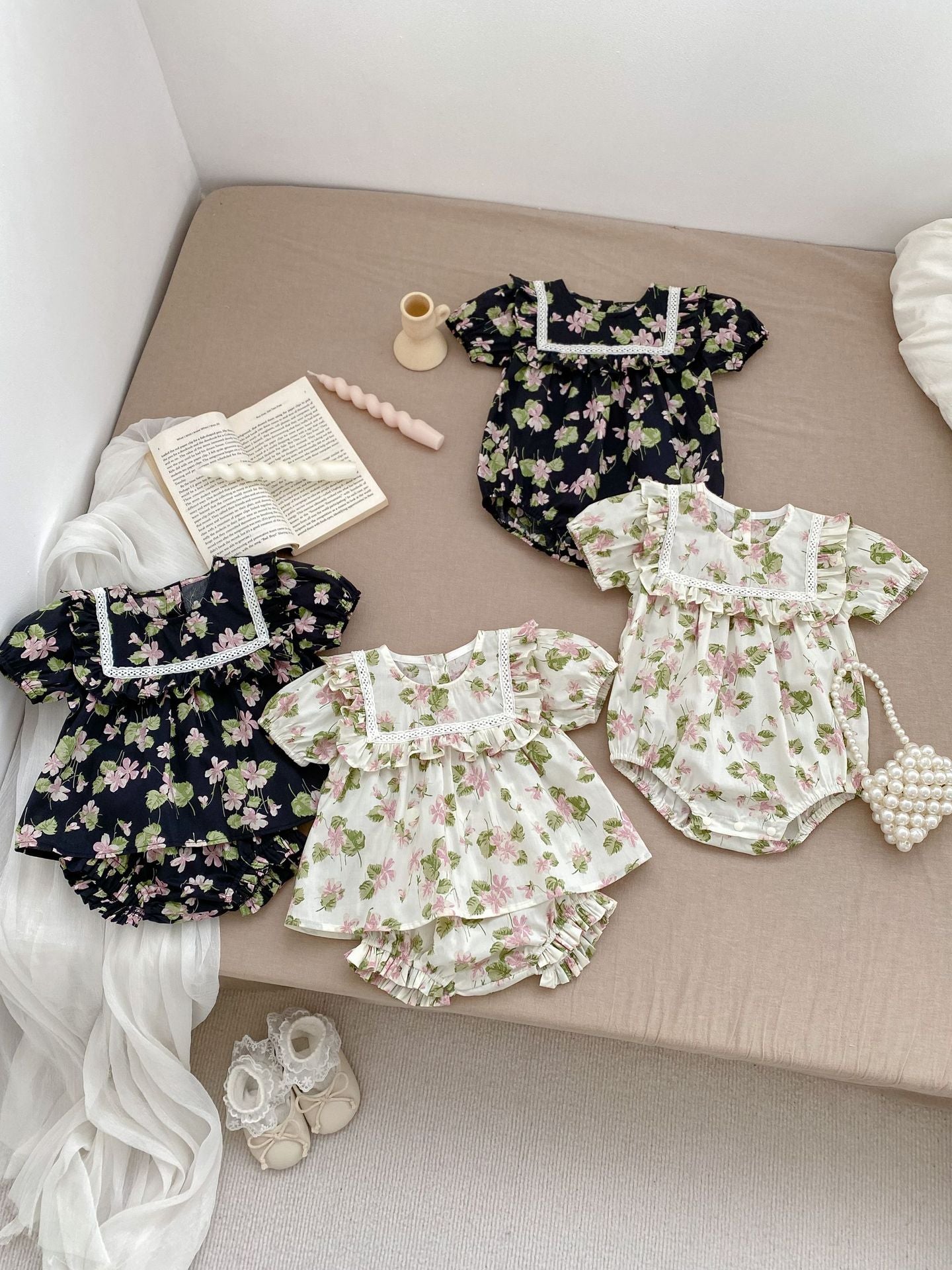 A cute summer dress for baby girls featuring a floral pattern, short sleeves, and available in multiple colors including black, pink, beige, and apricot.
