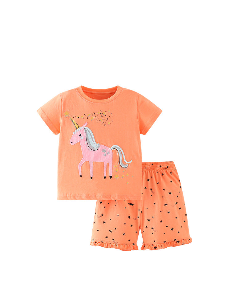 Summer outfit for baby girls featuring a unicorn and stars pattern in bright orange color, consisting of a T-shirt and shorts.