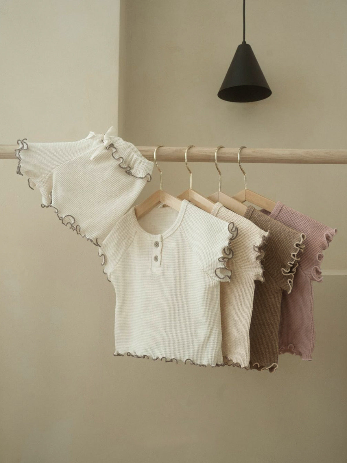 A collection of Summer Baby Kids Unisex Solid Color Waffle Grid Short Sleeves in Pink, Khaki, Beige, and Coffee colors, showcasing their casual style.