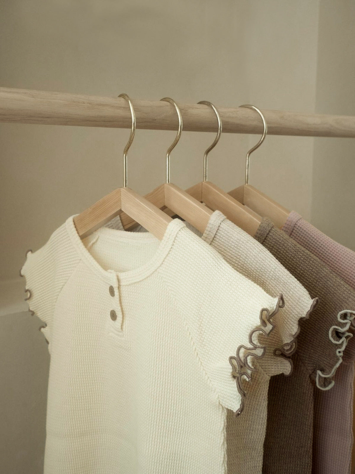 A collection of Summer Baby Kids Unisex Solid Color Waffle Grid Short Sleeves in Pink, Khaki, Beige, and Coffee colors, showcasing their casual style.