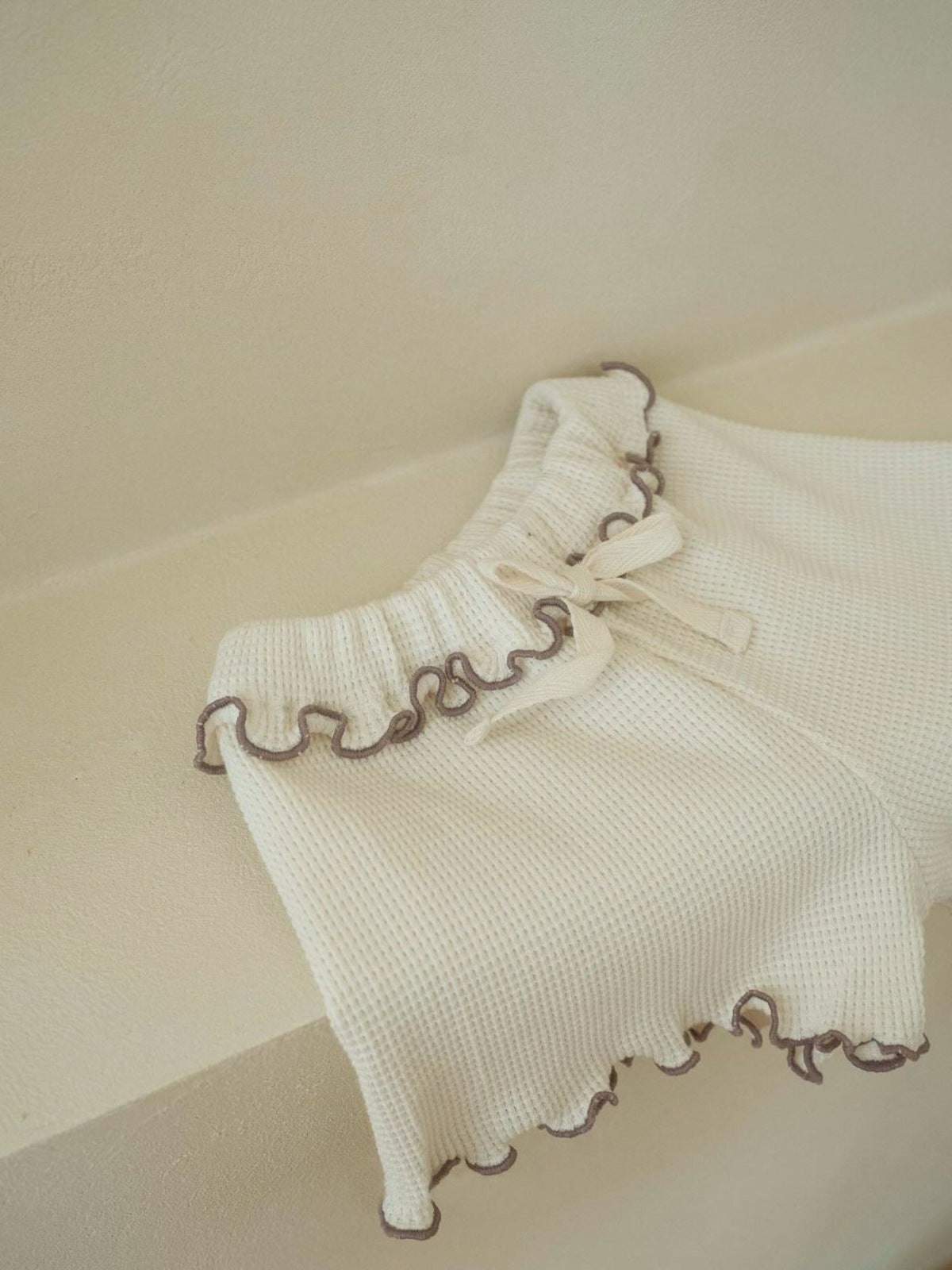 A collection of Summer Baby Kids Unisex Solid Color Waffle Grid Short Sleeves in Pink, Khaki, Beige, and Coffee colors, showcasing their casual style.