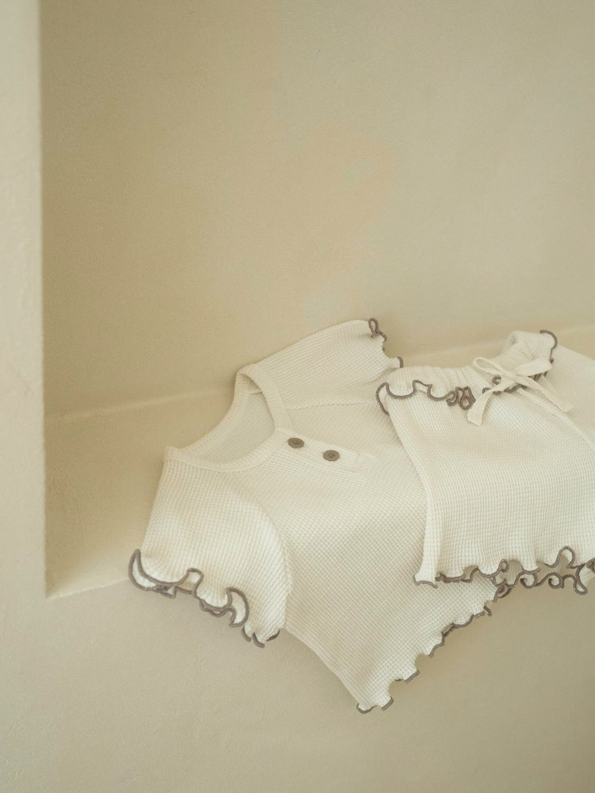 A collection of Summer Baby Kids Unisex Solid Color Waffle Grid Short Sleeves in Pink, Khaki, Beige, and Coffee colors, showcasing their casual style.