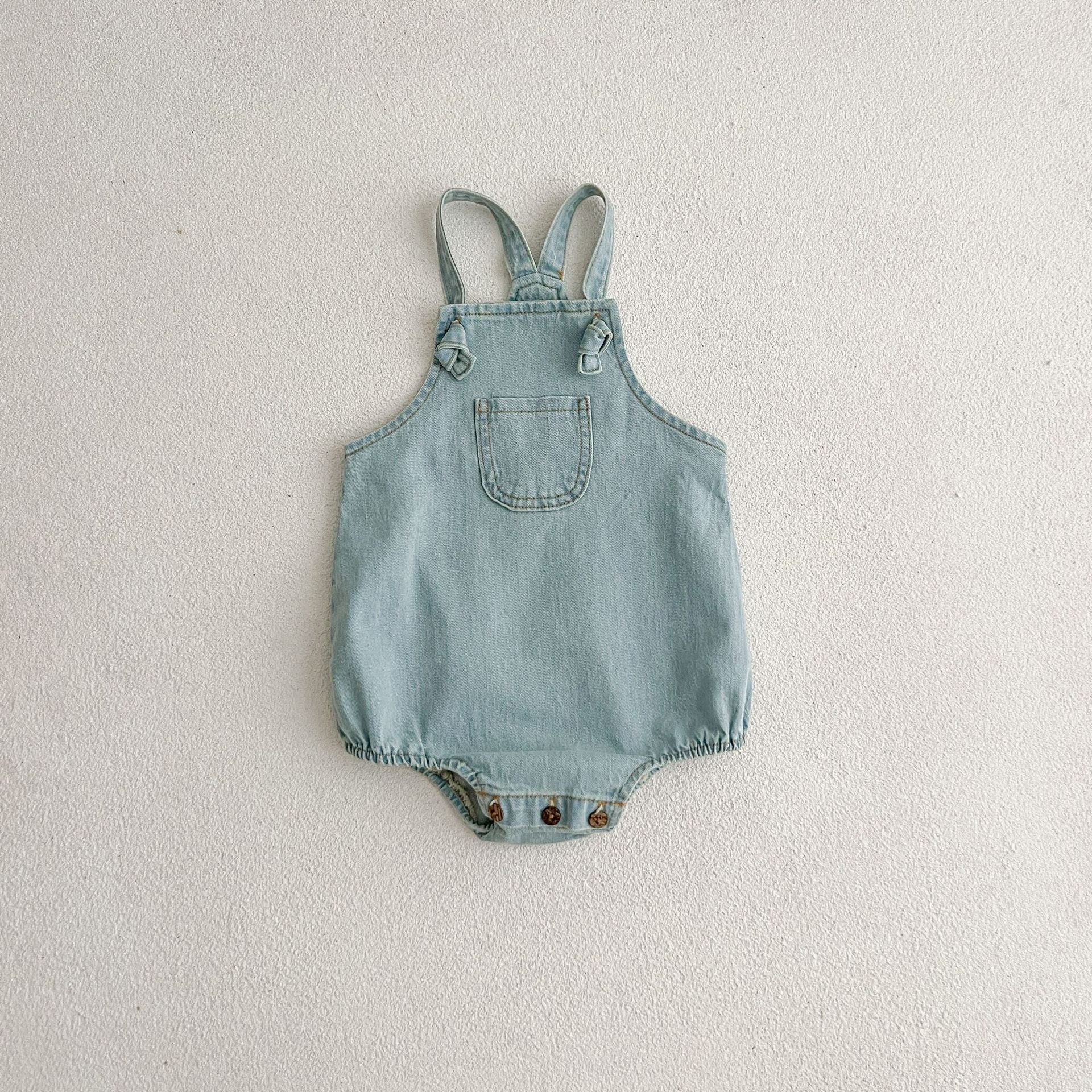 Summer Baby Kids Unisex Solid Color White Short Sleeves T-Shirt displayed on a hanger, showcasing its soft fabric and short sleeves.