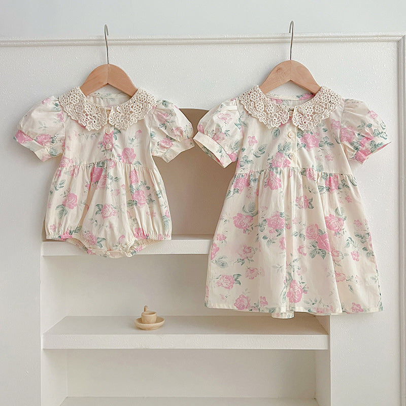 A cute summer dress for girls featuring a floral pattern and a hollow out Peter Pan collar, available in pink and beige.