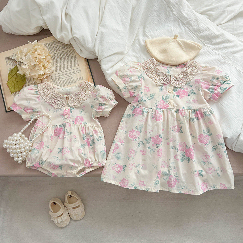 A cute summer dress for girls featuring a floral pattern and a hollow out Peter Pan collar, available in pink and beige.
