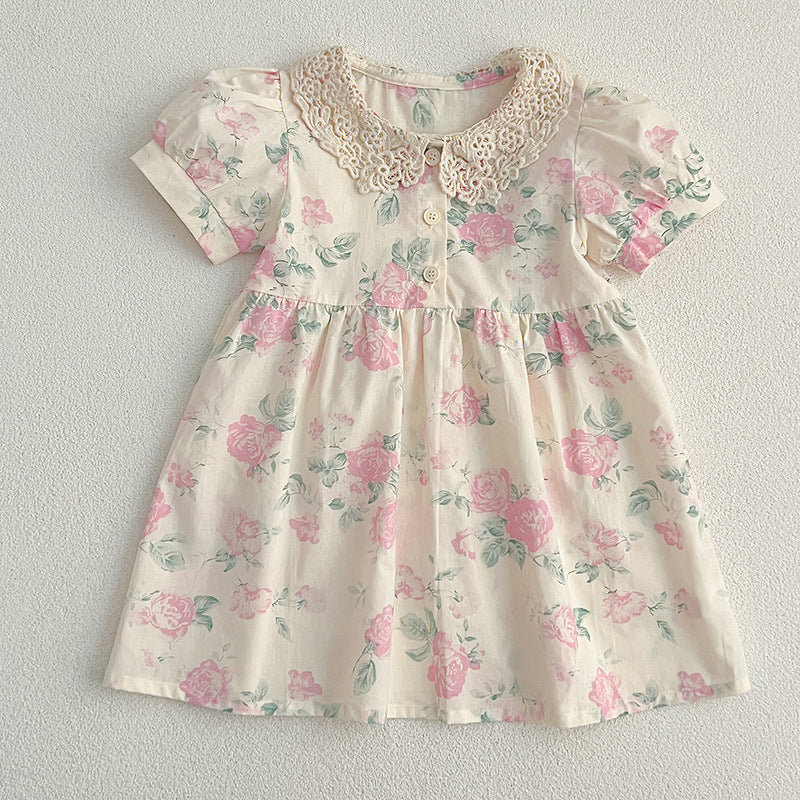 A cute summer dress for girls featuring a floral pattern and a hollow out Peter Pan collar, available in pink and beige.