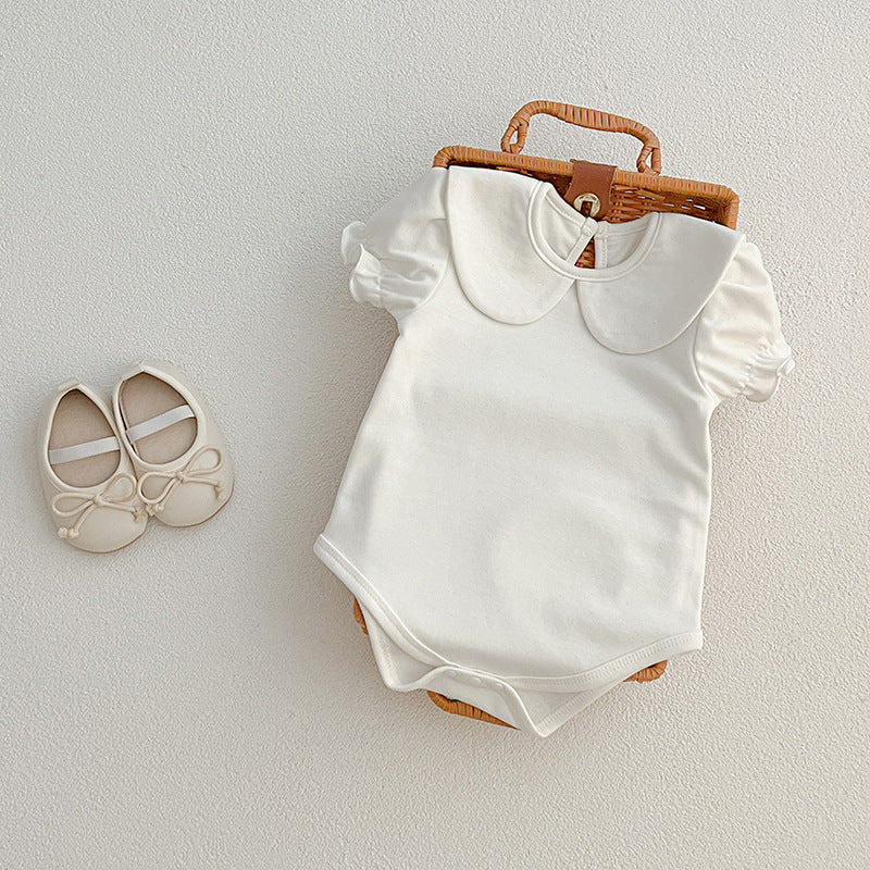 White baby romper with shoes.