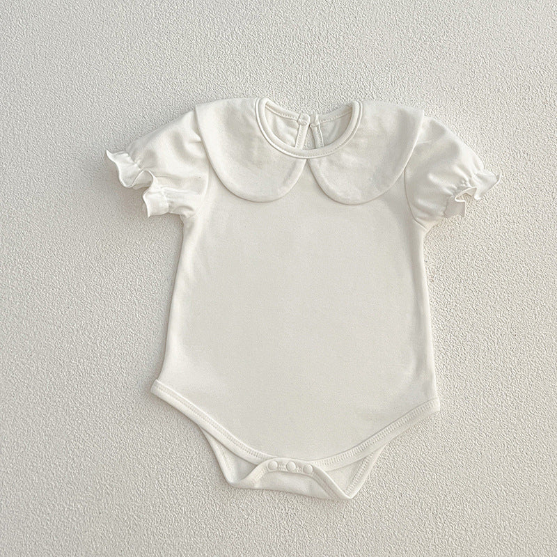 White baby onesie with ruffled sleeves.