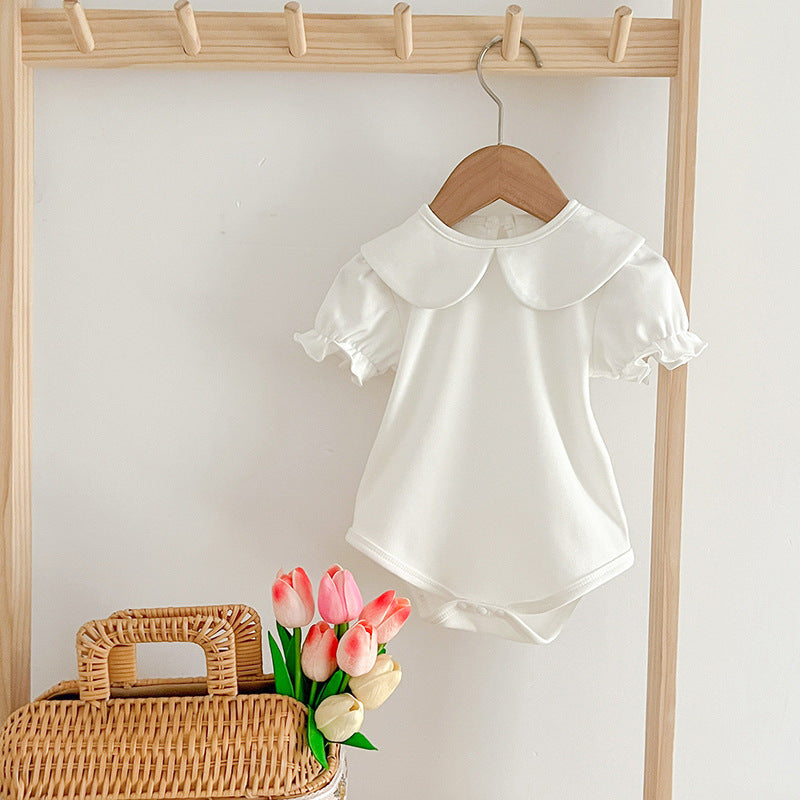 White baby onesie on hanger.