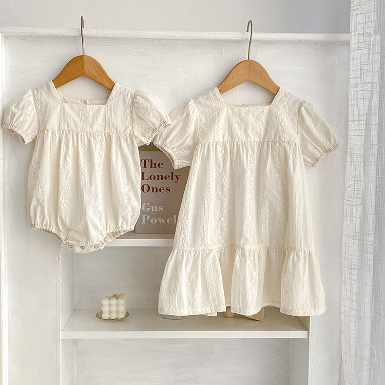 Summer girls onesies in beige and apricot with square neck and embroidery details, perfect for warm weather.