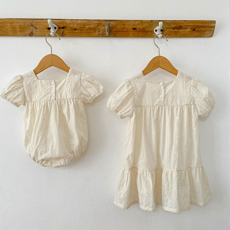 Summer girls onesies in beige and apricot with square neck and embroidery details, perfect for warm weather.