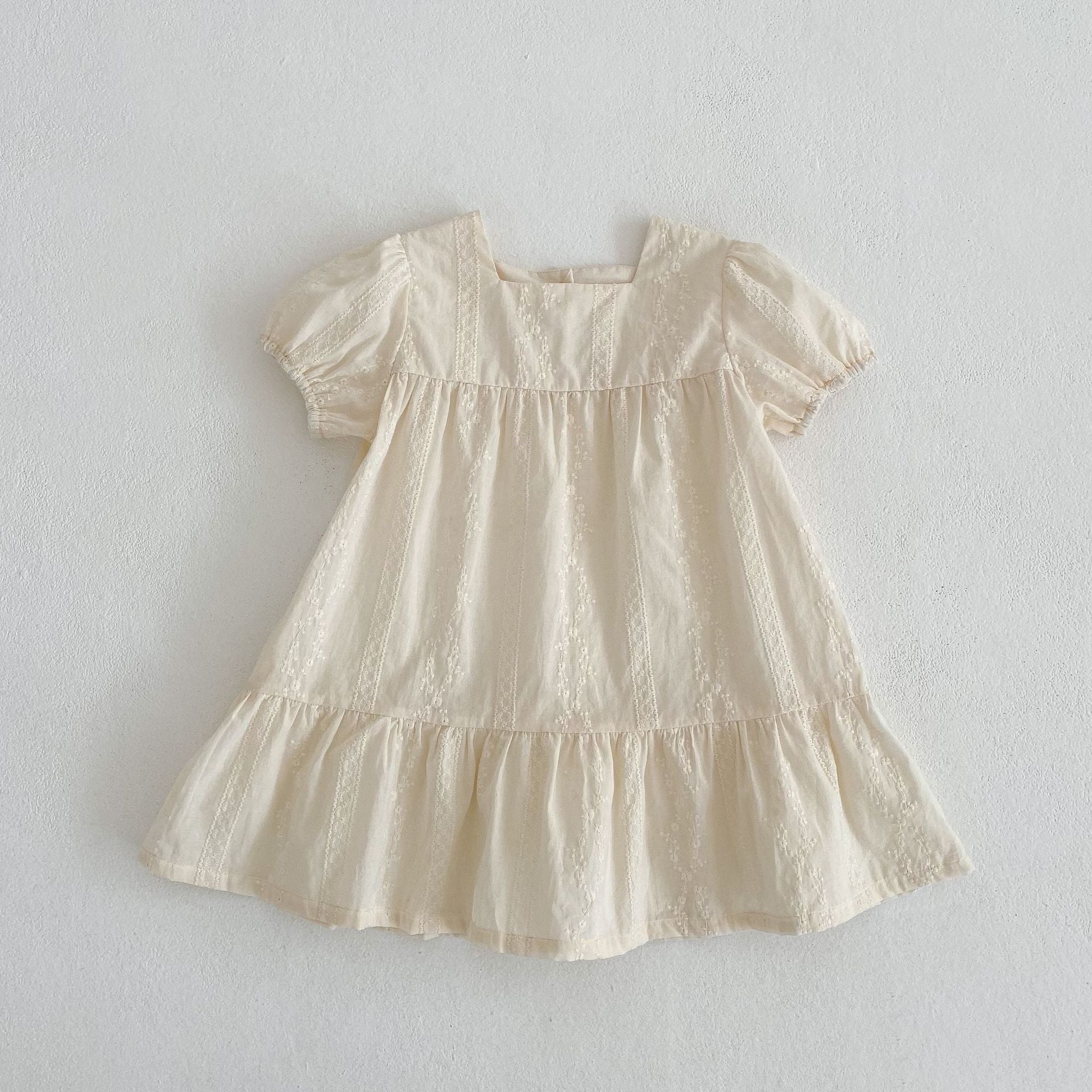 Summer girls onesies in beige and apricot with square neck and embroidery details, perfect for warm weather.
