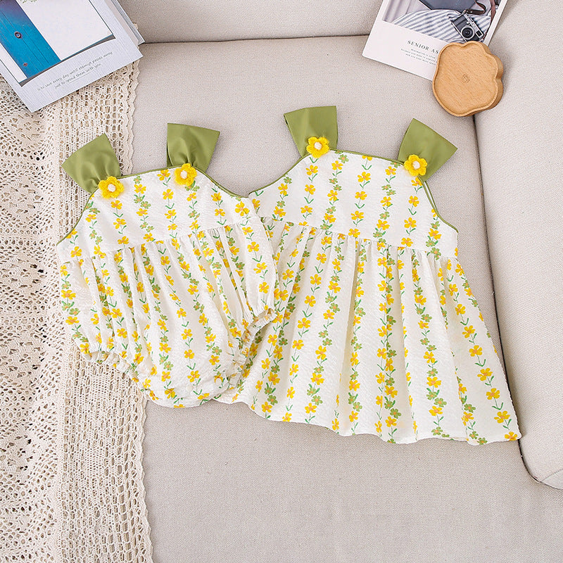 A bright yellow floral pattern sleeveless strap onesie for girls, showcasing vibrant flowers on a soft fabric.