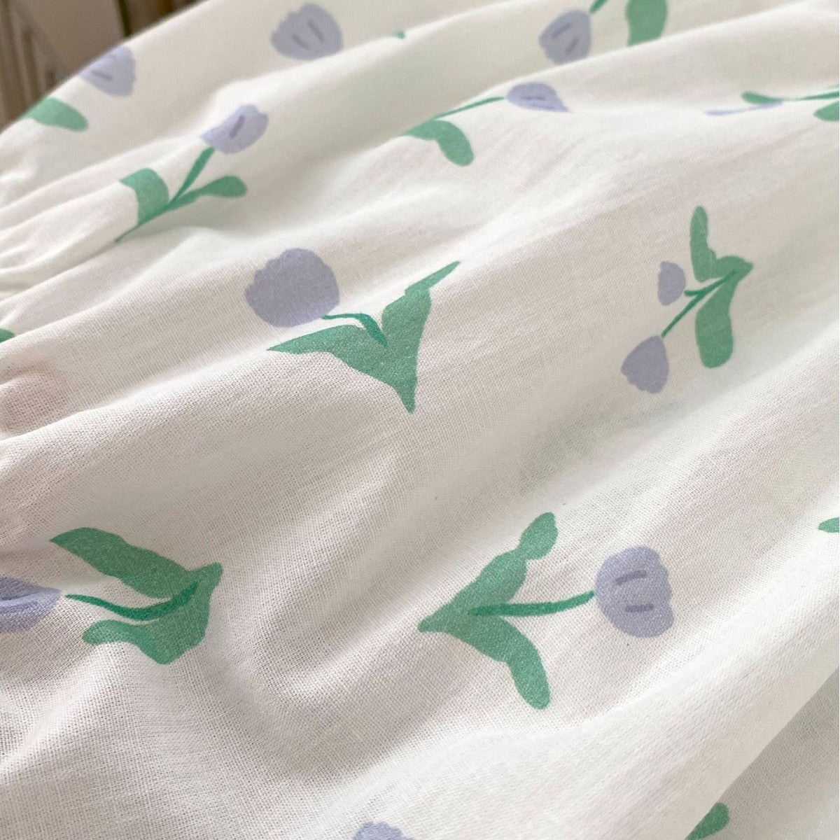 A cute purple floral pattern sleeveless strap onesie for baby girls, perfect for summer wear.