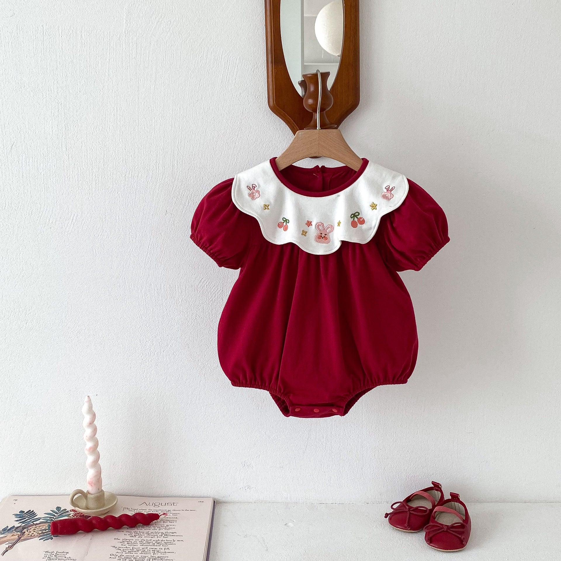 A vibrant red short-sleeved crew neck top for baby girls featuring beautiful embroidery, made from soft cotton material, perfect for summer wear.