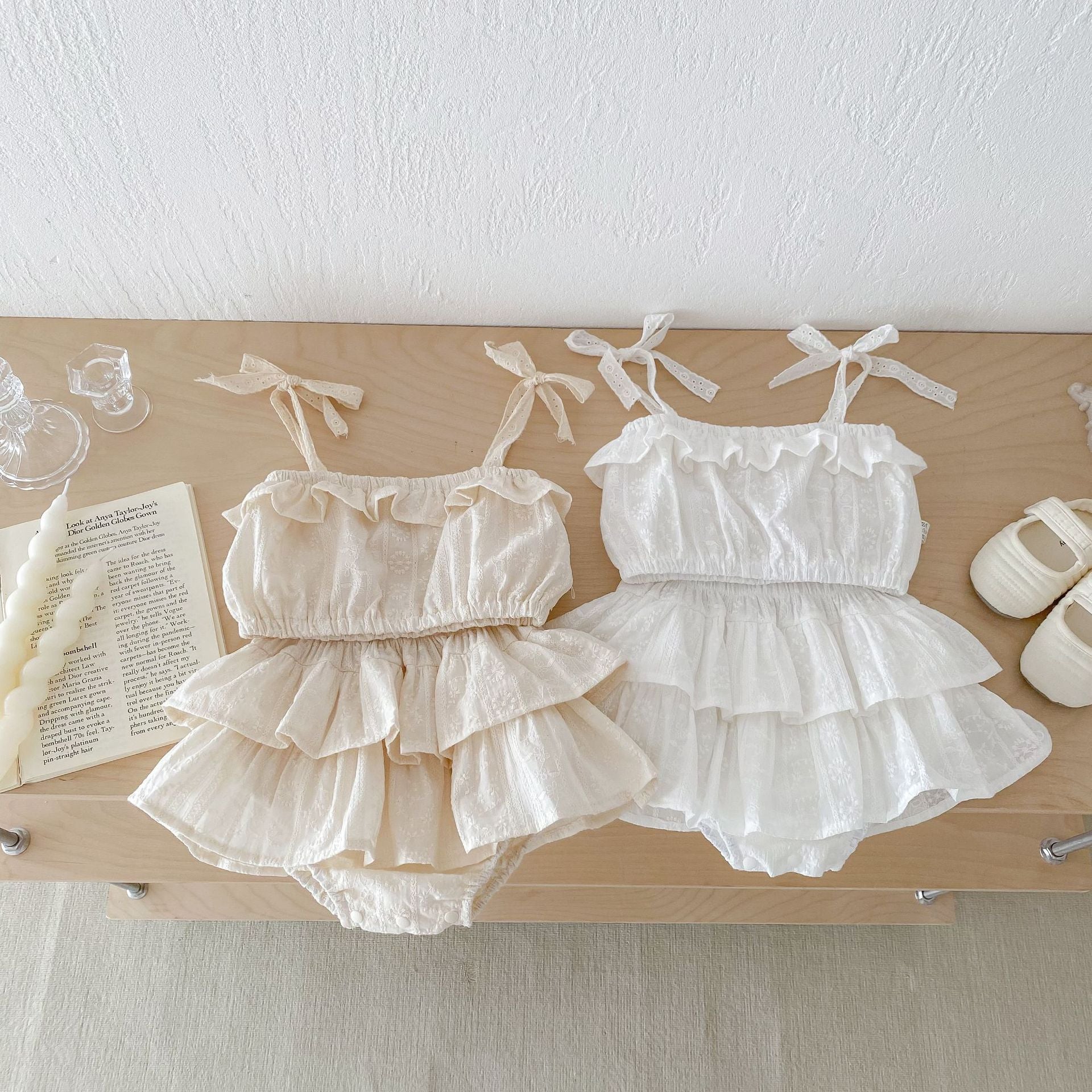 A cute baby girl wearing a sleeveless floral embroidery dress in white, perfect for summer outings.