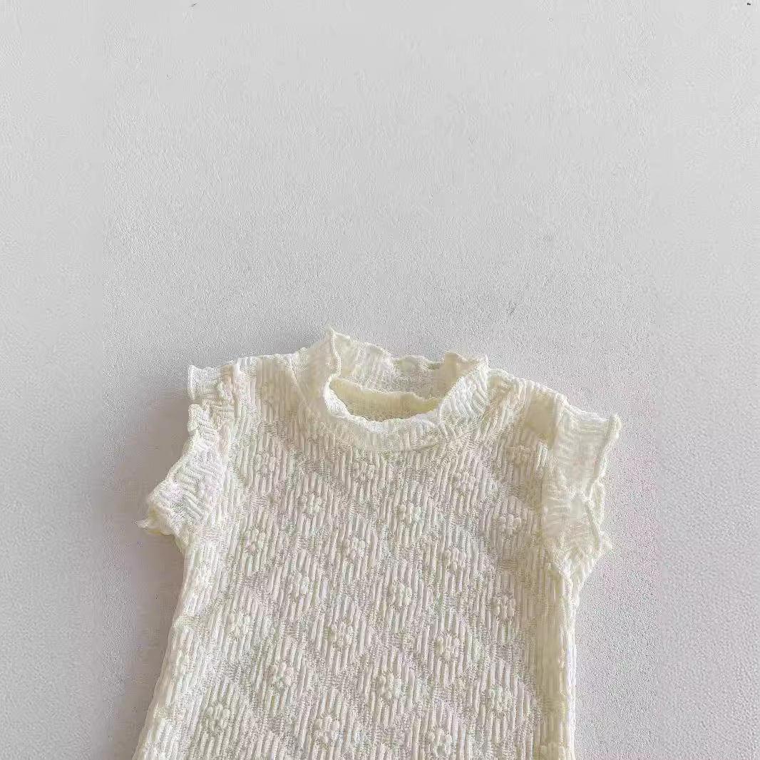 A cute baby girl wearing a green sleeveless floral pattern strap romper, perfect for summer outings.