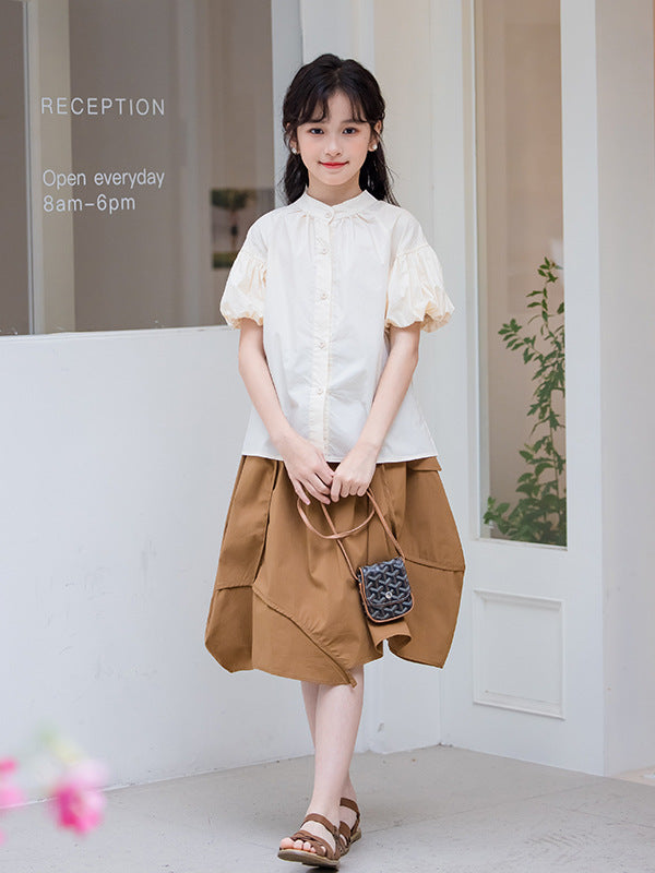 Girls solid color short sleeves top in apricot, made from soft cotton, perfect for summer wear.