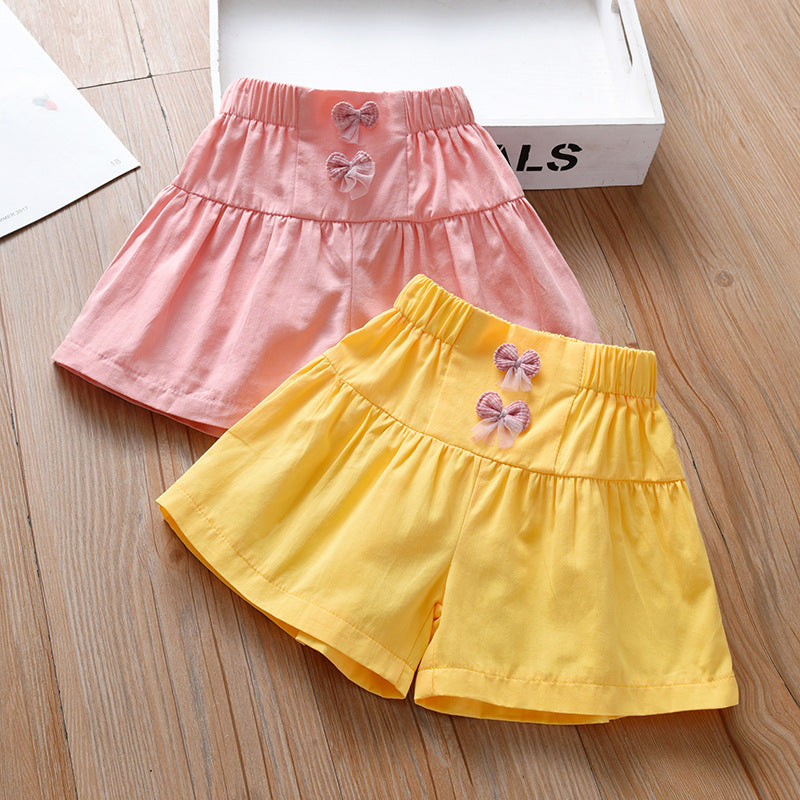 Summer Kids Girls Casual Shorts in pink and yellow with bows, made from soft breathable cotton, perfect for summer wear.