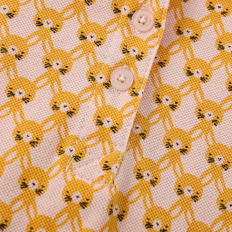 A vibrant yellow shirt for girls featuring a cute numerous rabbits pattern and a classic turn-down collar, perfect for summer wear.