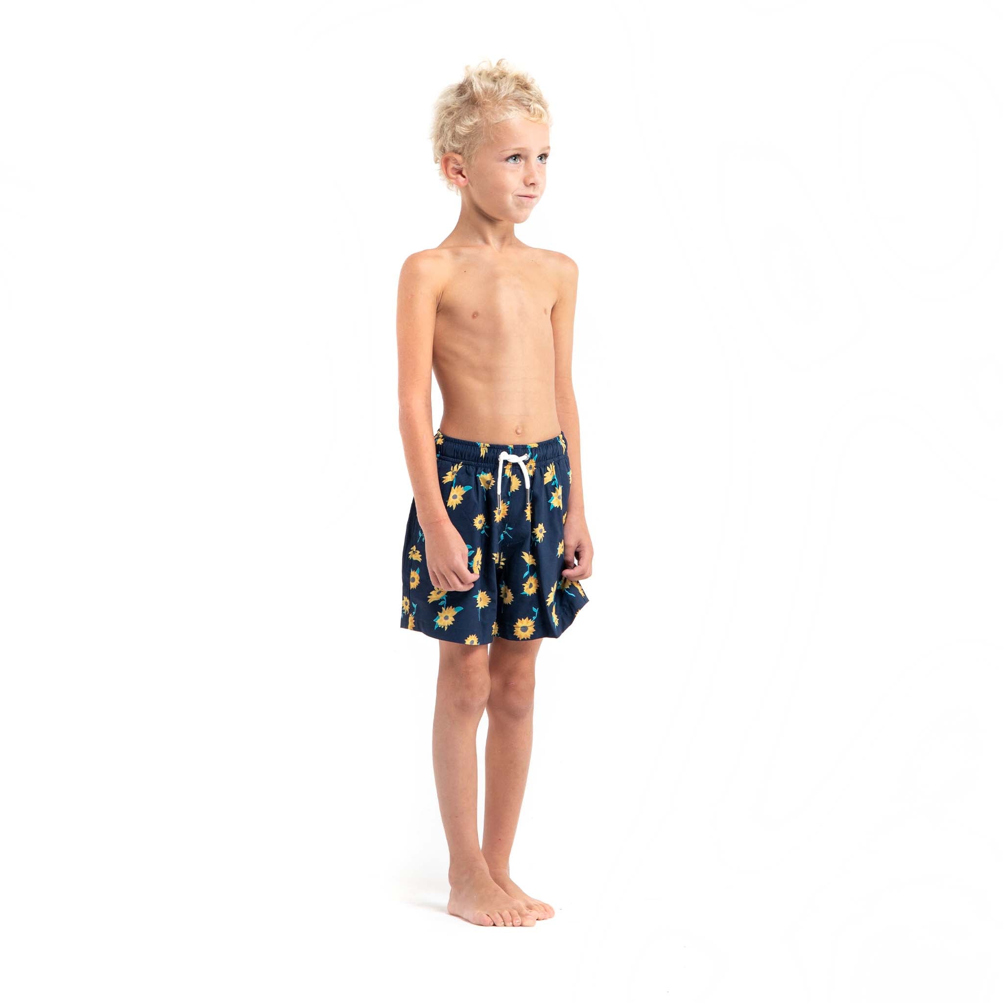 Bright and colorful Sunflower Kids swim trunks made from recycled materials, featuring a stretchy mesh liner and multiple pockets.