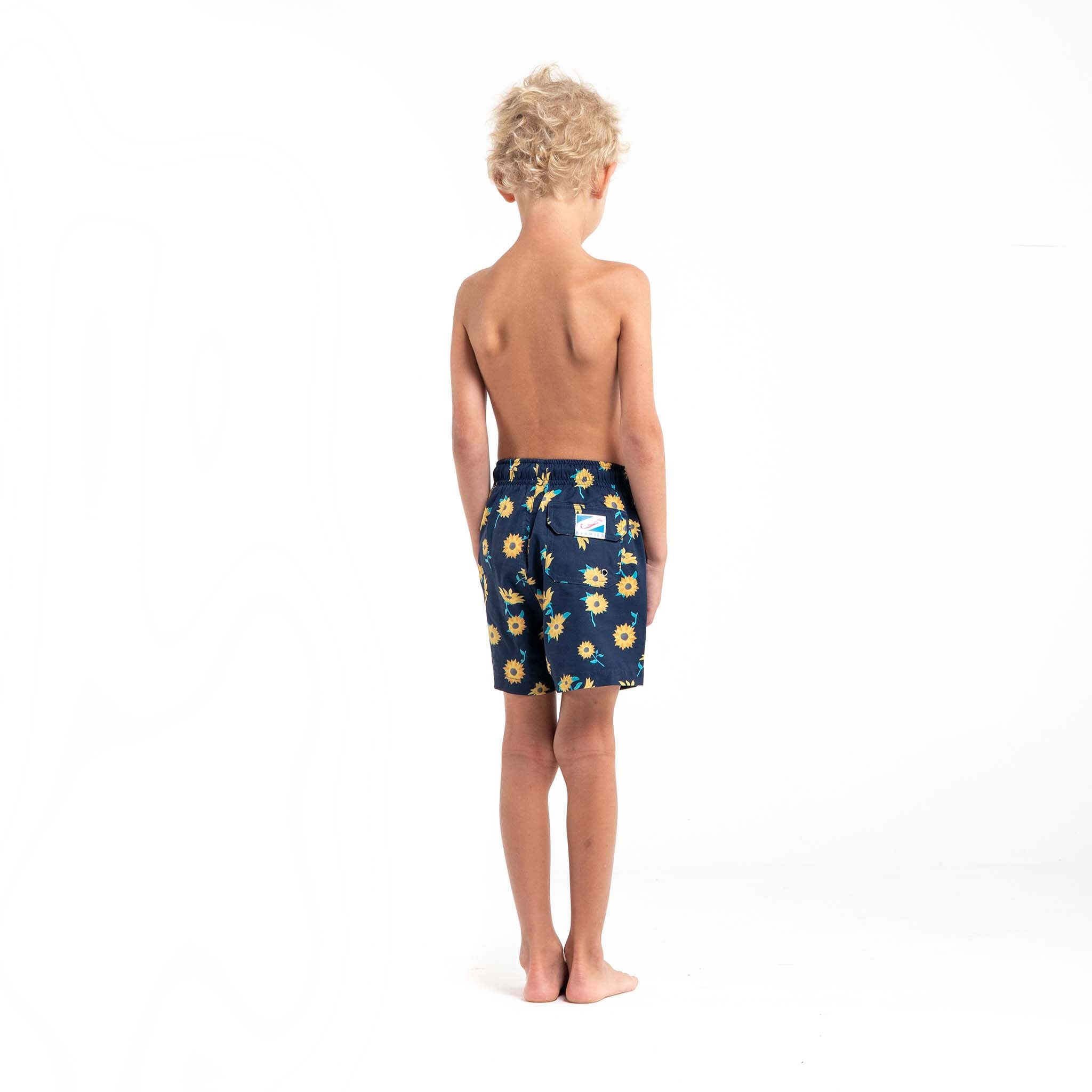 Bright and colorful Sunflower Kids swim trunks made from recycled materials, featuring a stretchy mesh liner and multiple pockets.