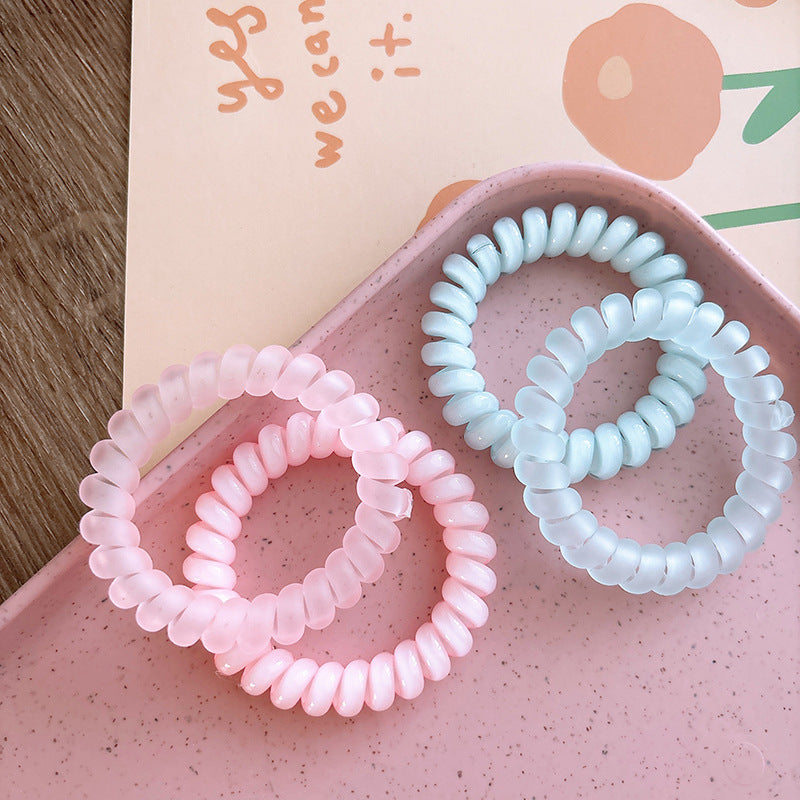 Sweet and Refreshing Matte Telephone Cord Style Hair Tie in pink and blue, designed for baby girls and girls, made from durable resin material.