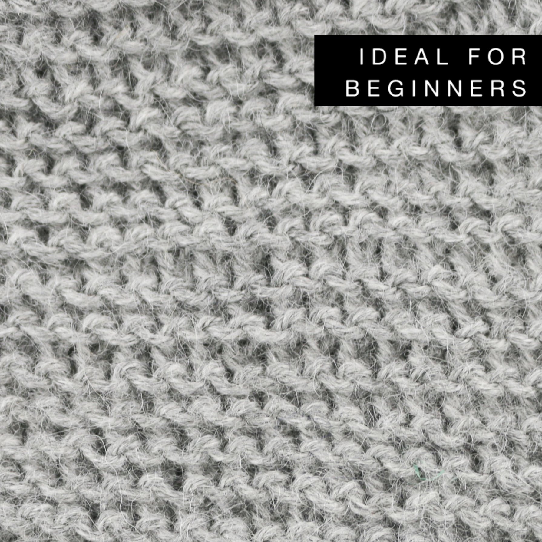 Titi Hood Knitting Kit featuring grey baby alpaca yarn, wooden knitting needles, and accessories for beginners.