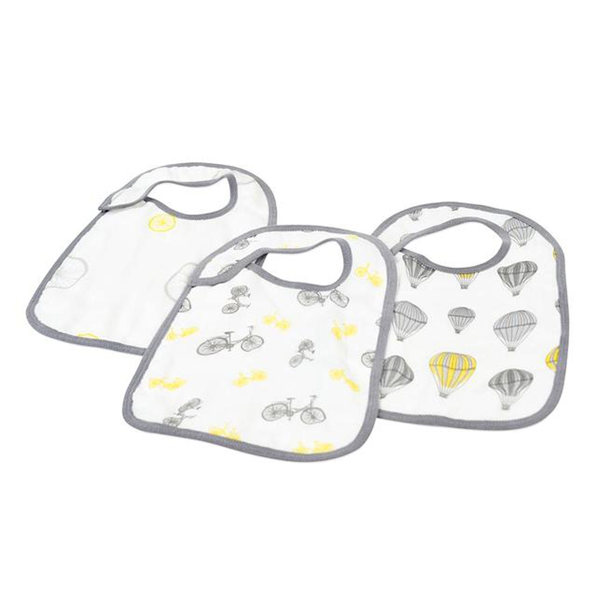 A pack of three stylish Traveler Bamboo Muslin Snap Bibs featuring adjustable snaps and soft, absorbent fabric, perfect for feeding and teething.