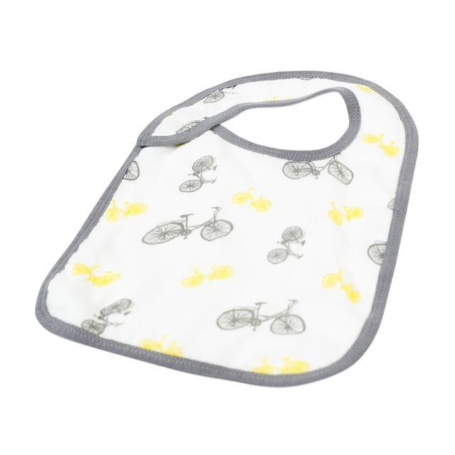 A pack of three stylish Traveler Bamboo Muslin Snap Bibs featuring adjustable snaps and soft, absorbent fabric, perfect for feeding and teething.