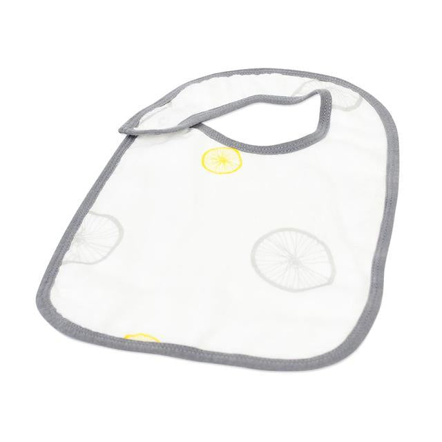 A pack of three stylish Traveler Bamboo Muslin Snap Bibs featuring adjustable snaps and soft, absorbent fabric, perfect for feeding and teething.