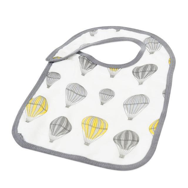 A pack of three stylish Traveler Bamboo Muslin Snap Bibs featuring adjustable snaps and soft, absorbent fabric, perfect for feeding and teething.