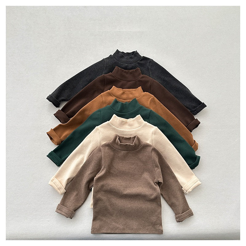 Unisex Baby Kids Stretch Solid Long Sleeve Sweatshirt in various colors, showcasing its soft fabric and versatile design.