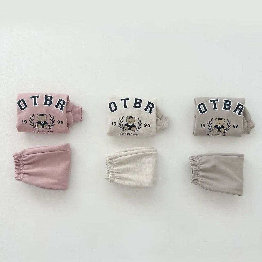 Unisex Baby Letter Print Combo featuring a cartoon pattern top and long pants in pink, grey, and apricot colors, perfect for baby girls.