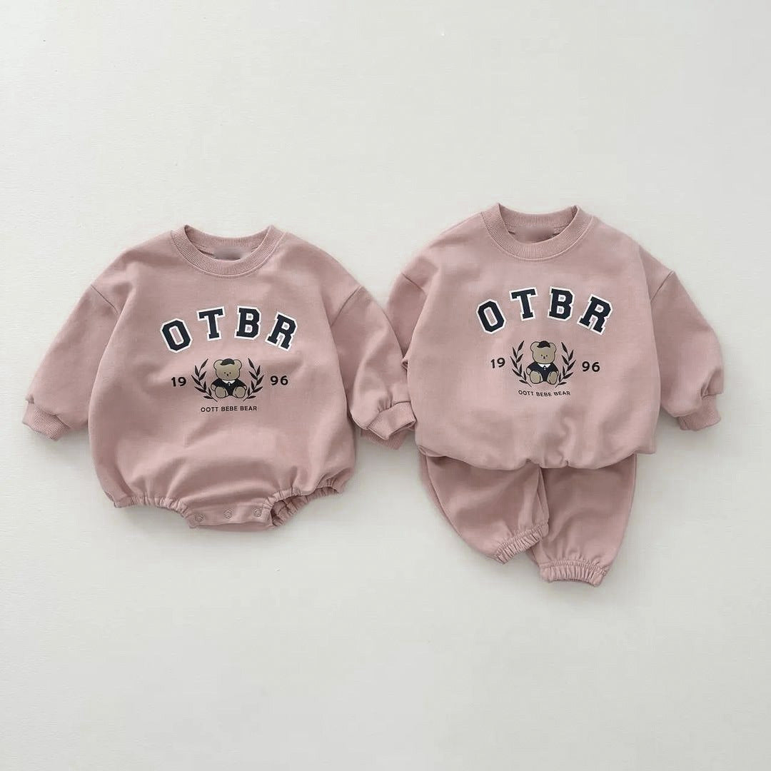 Unisex Baby Letter Print Combo featuring a cartoon pattern top and long pants in pink, grey, and apricot colors, perfect for baby girls.