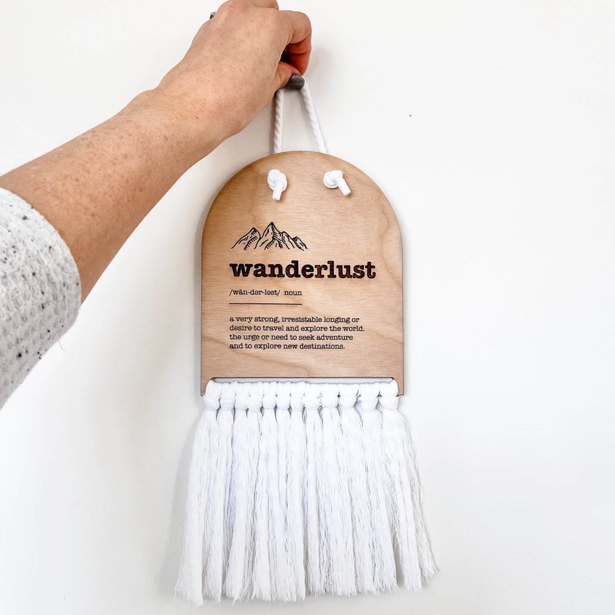Wanderlust Half Moon Macrame Sign featuring elegant laser cut lettering and macrame rope for easy hanging, perfect for home decor.