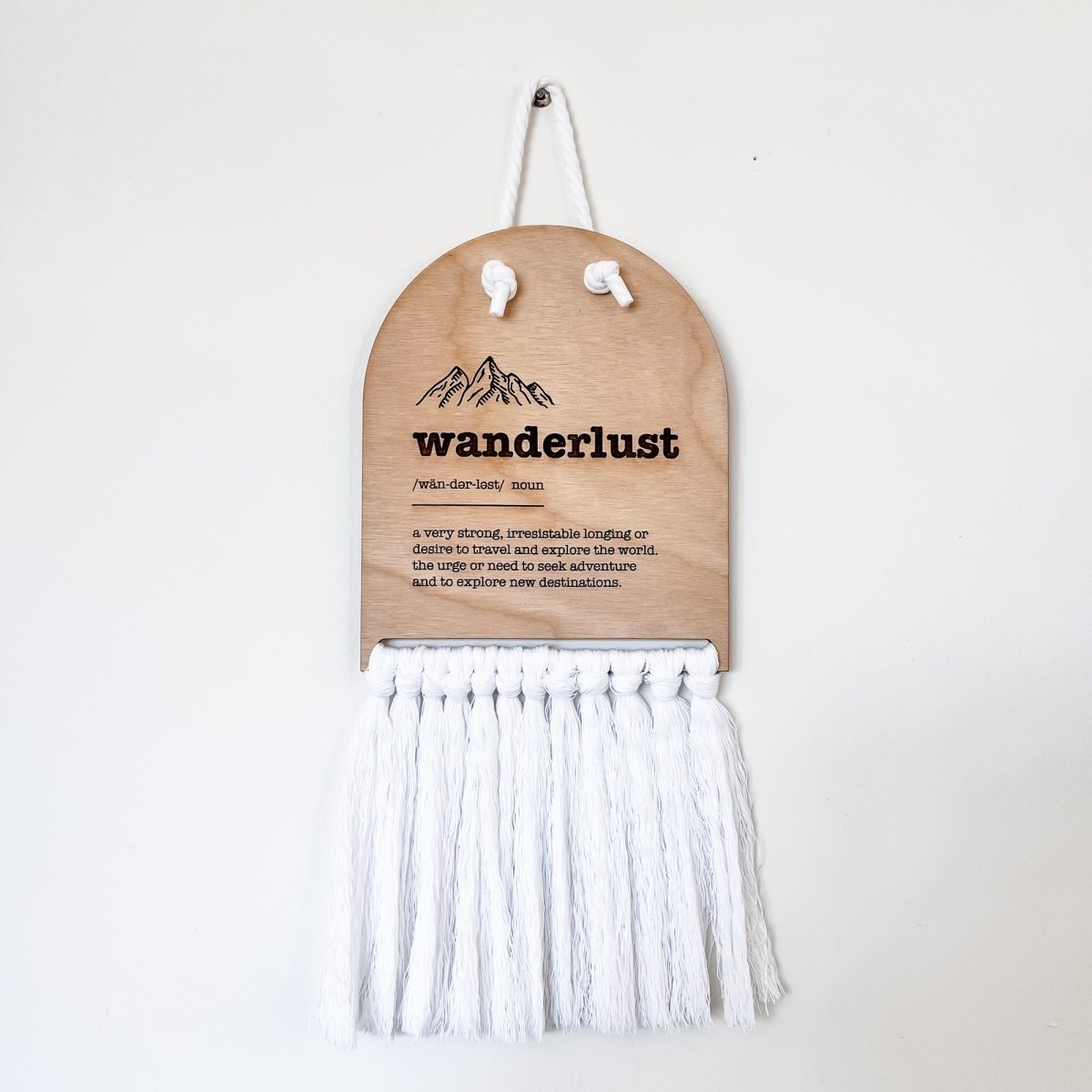 Wanderlust Half Moon Macrame Sign featuring elegant laser cut lettering and macrame rope for easy hanging, perfect for home decor.