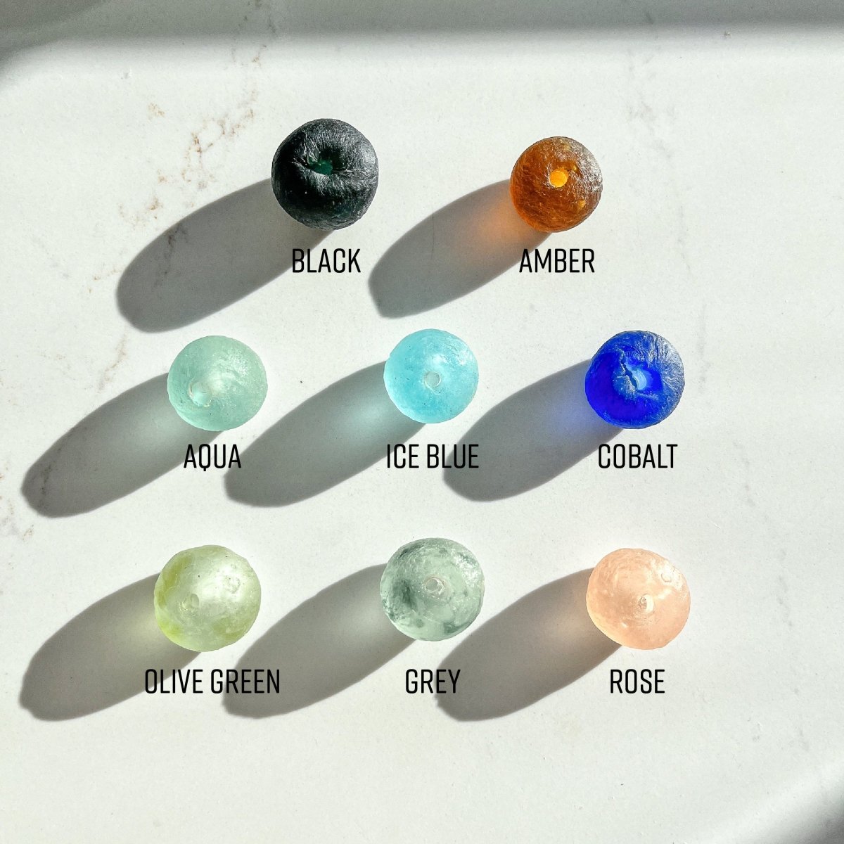 A beautifully handcrafted Whitewashed Wood Bead Garland featuring Jumbo Cobalt Blue Recycled Glass beads, perfect for coastal decor.