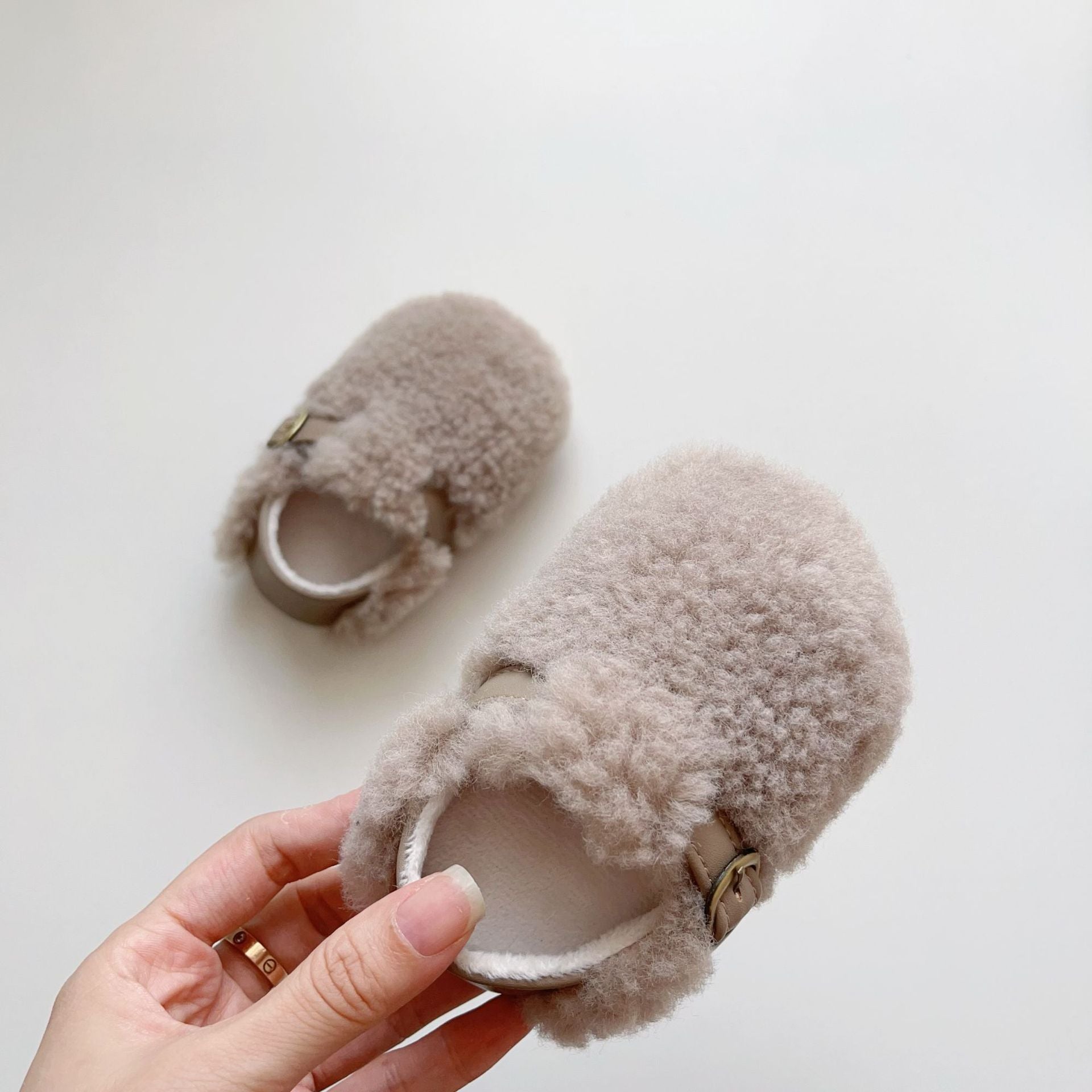 Cozy fleece toddler shoes in white, grey, and apricot colors, designed for comfort and warmth during winter.