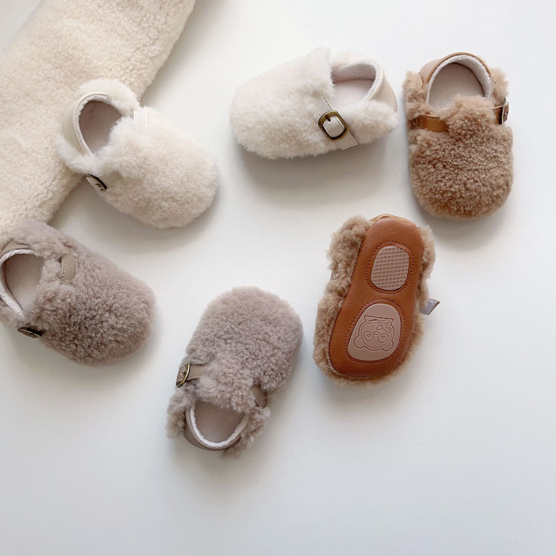 Cozy fleece toddler shoes in white, grey, and apricot colors, designed for comfort and warmth during winter.