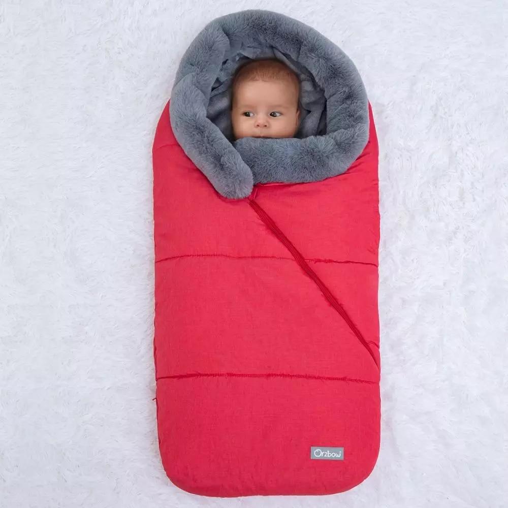 Winter Sleeping Bag Envelope for newborns, featuring a hood and faux fur collar, available in various colors.