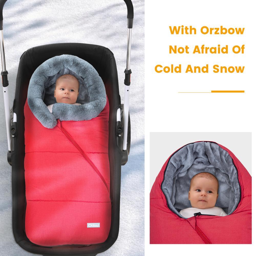Winter Sleeping Bag Envelope for newborns, featuring a hood and faux fur collar, available in various colors.