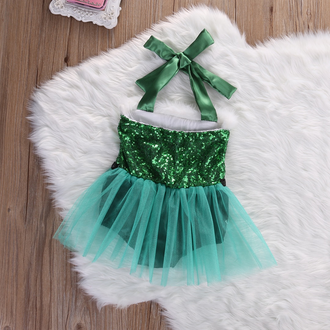 Green sequined tutu dress on rug.