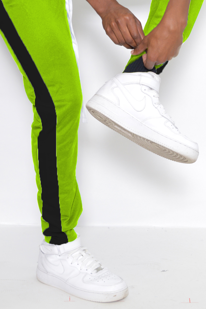 Classic Slim Fit Track Pants featuring a single stripe detail and hidden ankle zipper, modeled by a 5'11 individual in Medium size.